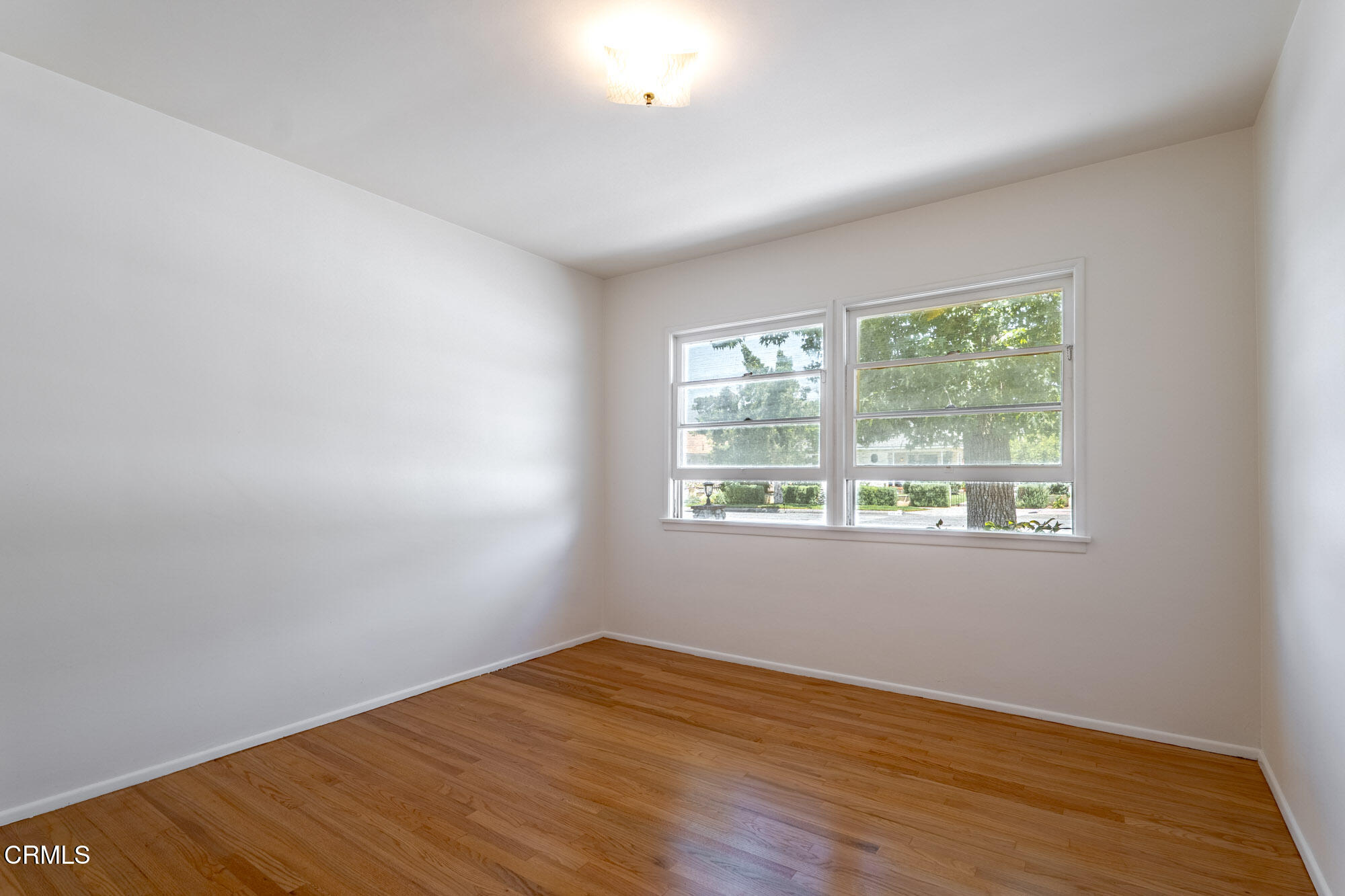 890 Arwin Street Pasadena, CA 91103 - Photo 10 of 40 an empty room with wooden floor and windows