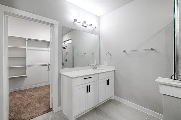 a spacious bathroom with a double vanity sink and a mirror