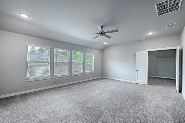 an empty room with a empty space and windows