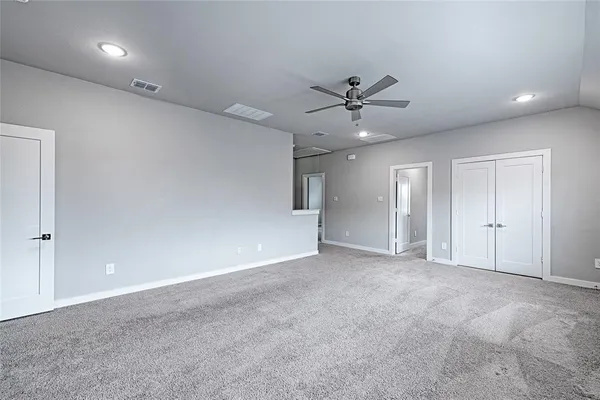 a view of an empty room with a ceiling fan