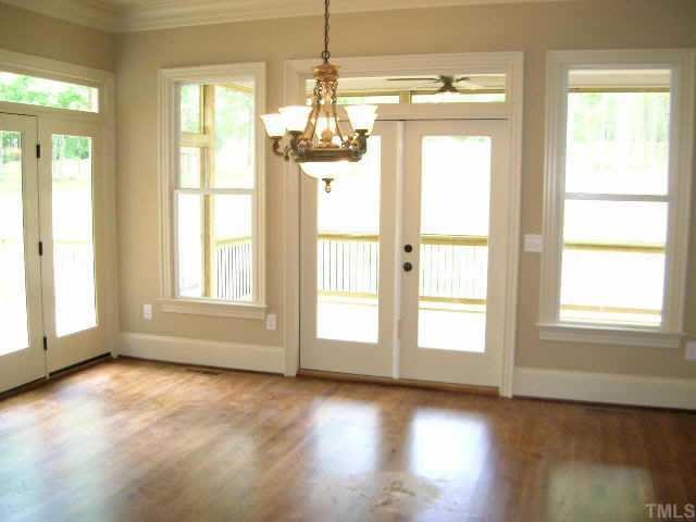 1812 Silver Mist Court Raleigh, NC 27613 - Photo 6 of 10 a view of empty room with wooden floor and fan