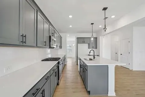 a bathroom with a bathtub shower sink vanity mirror and toilet