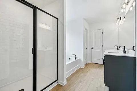 a front view of a house with a garden and trees