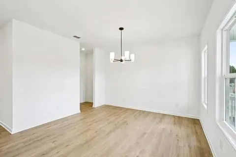 a view of a room with a kitchen and entryway