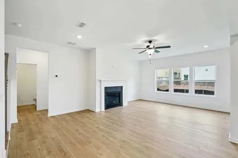 a kitchen with stainless steel appliances granite countertop a sink a stove and a wooden floors