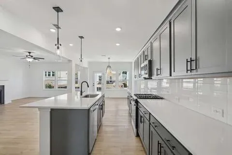 a kitchen with stainless steel appliances a sink stove and cabinets