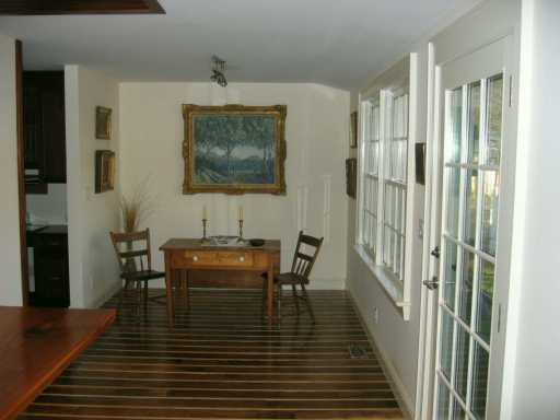 Undisclosed Address Darien, CT 06820 - Photo 7 of 8 a view of a dining room with furniture window and wooden floor