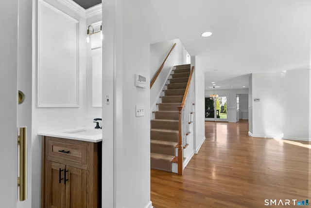 a view of a hallway with wooden floor and entryway