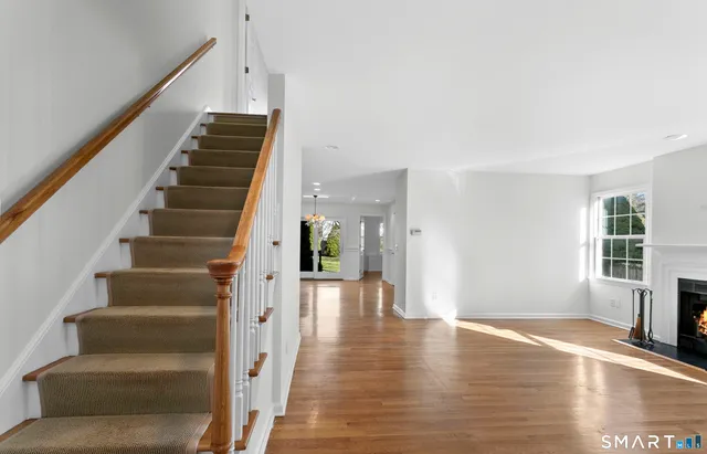 a view of entryway and hall with wooden floor