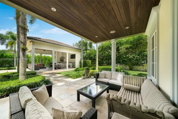 a view of a patio with couches chairs and a table and chairs