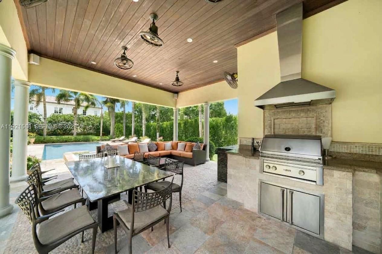 8010 Ponce De Leon Road Miami, FL 33143 - Photo 13 of 31 a dining room with furniture a rug and a floor to ceiling window