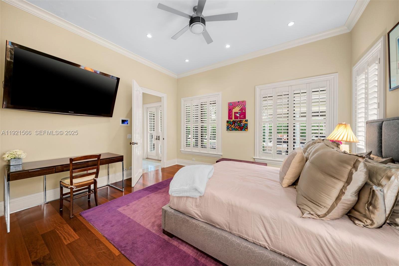 8010 Ponce De Leon Road Miami, FL 33143 - Photo 14 of 26 a bedroom with a bed a flat screen tv and a large window