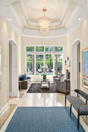 a living room with fireplace furniture and a large window