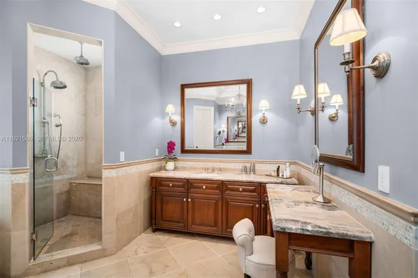 a bathroom with a granite countertop sink mirror and shower