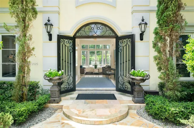 a view of a house with potted plants