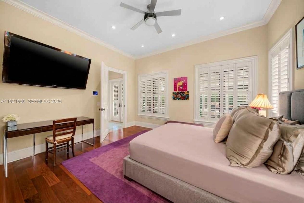 8010 Ponce De Leon Road Miami, FL 33143 - Photo 25 of 31 a bedroom with a bed a flat screen tv and a large window