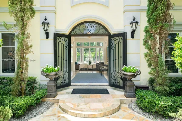 a view of a house with potted plants