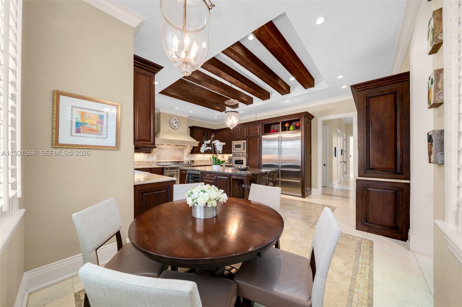 8010 Ponce De Leon Road Miami, FL 33143 - Photo 8 of 31 a dining room with furniture a kitchen and chandelier