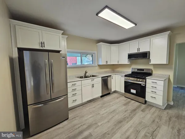 a kitchen with a refrigerator stove and microwave