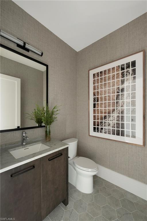 6704 Newport Road Naples, FL 34109 - Photo 32 of 47 a bathroom with a toilet sink a window and shower