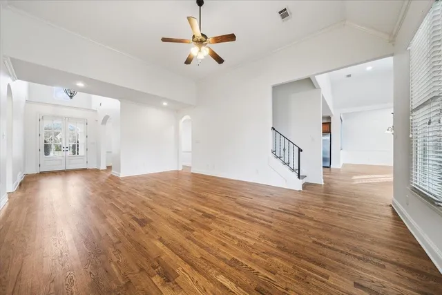 a view of an empty room and wooden floor