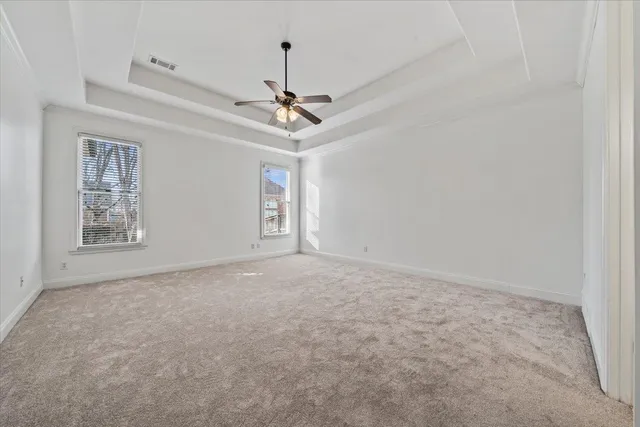 a view of a livingroom with a ceiling fan and window