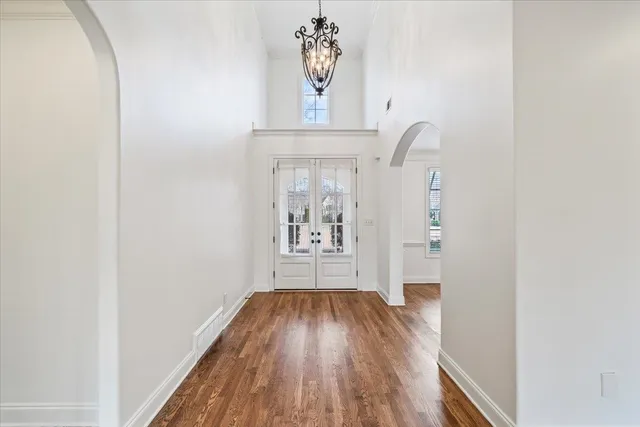 a view of a hallway with wooden floor and staircase