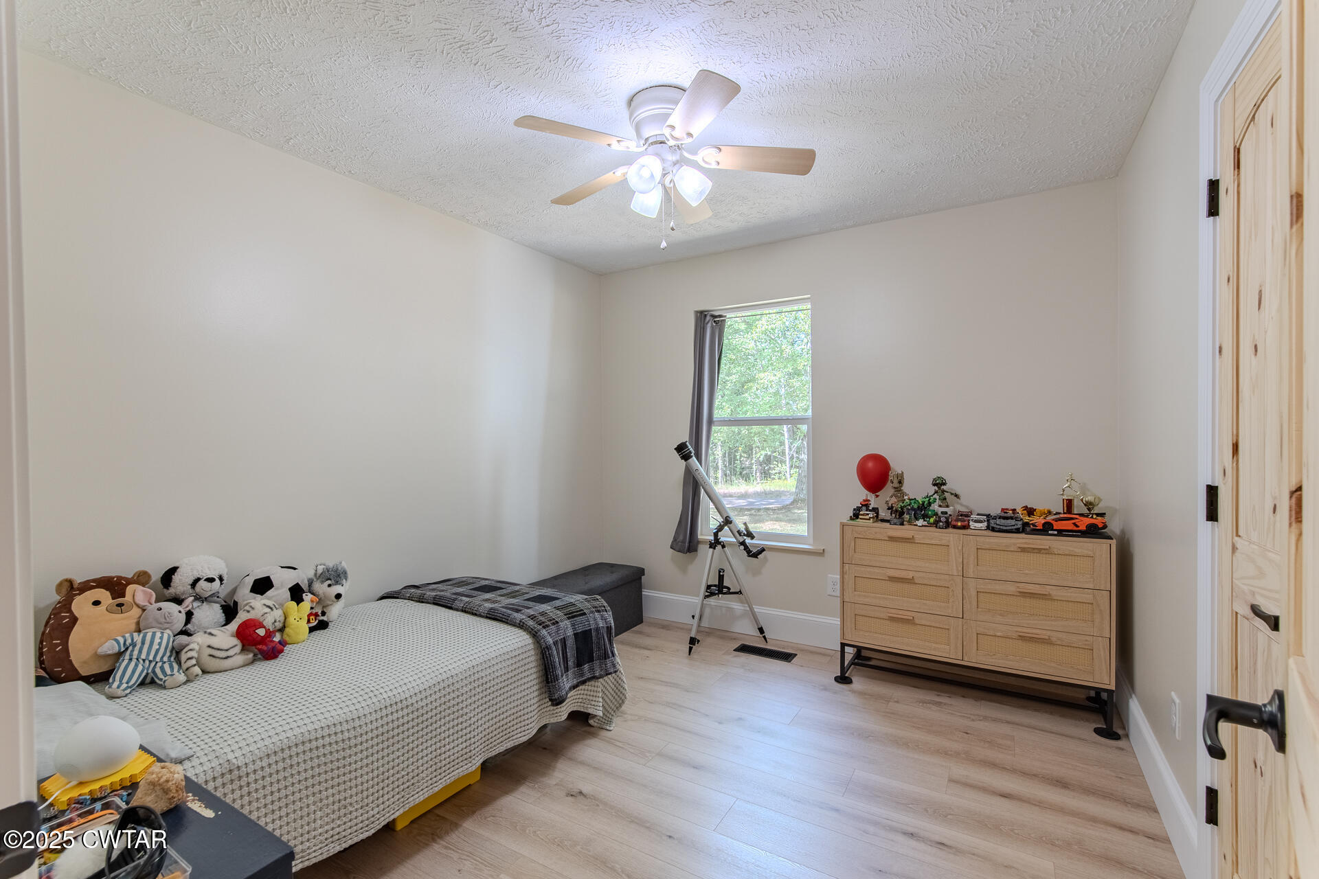 1000 Verles King Road Medon, TN 38356 - Photo 17 of 34 a bedroom with bed and a chandelier