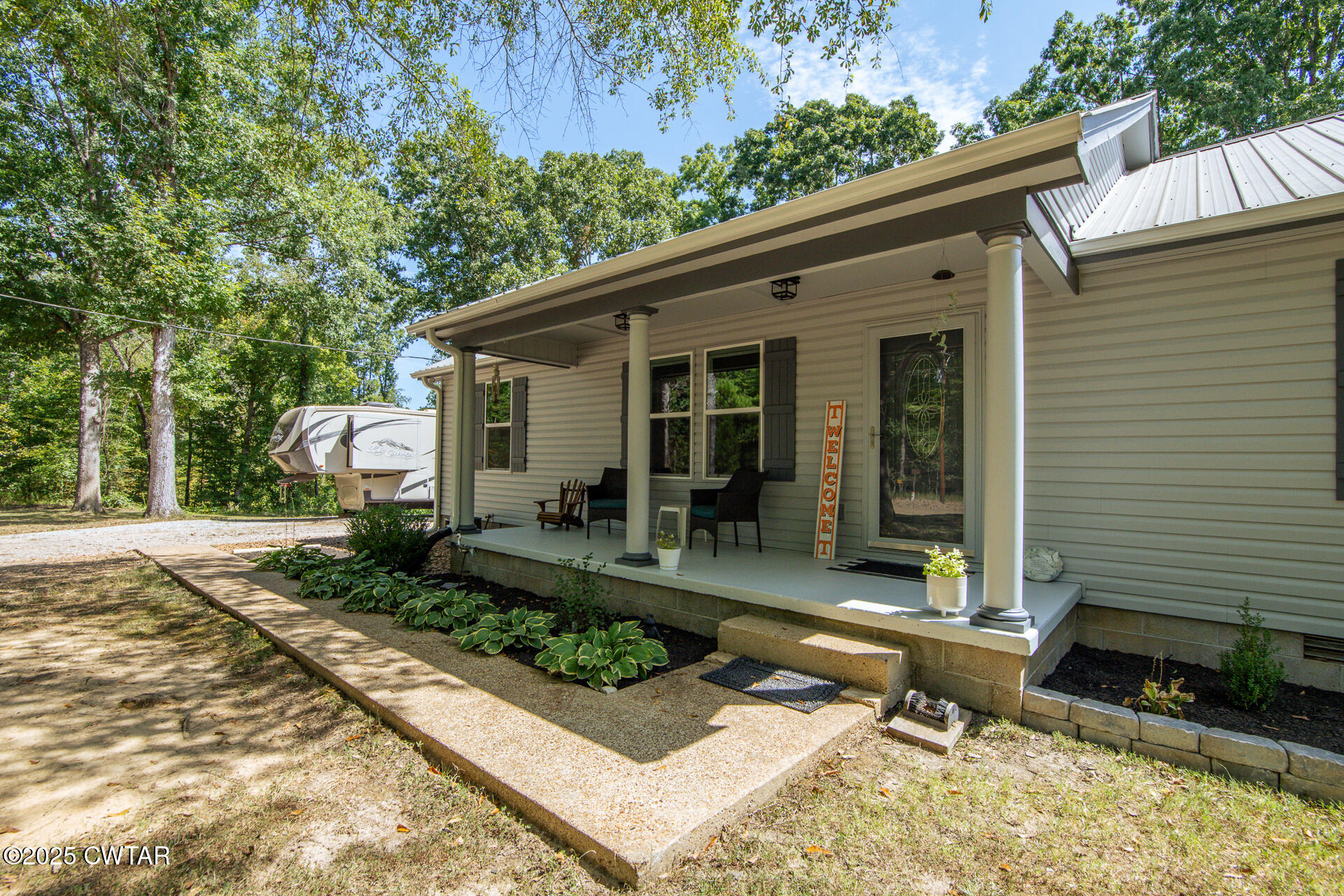 1000 Verles King Road Medon, TN 38356 - Photo 3 of 34 a view of house with backyard outdoor seating and trees