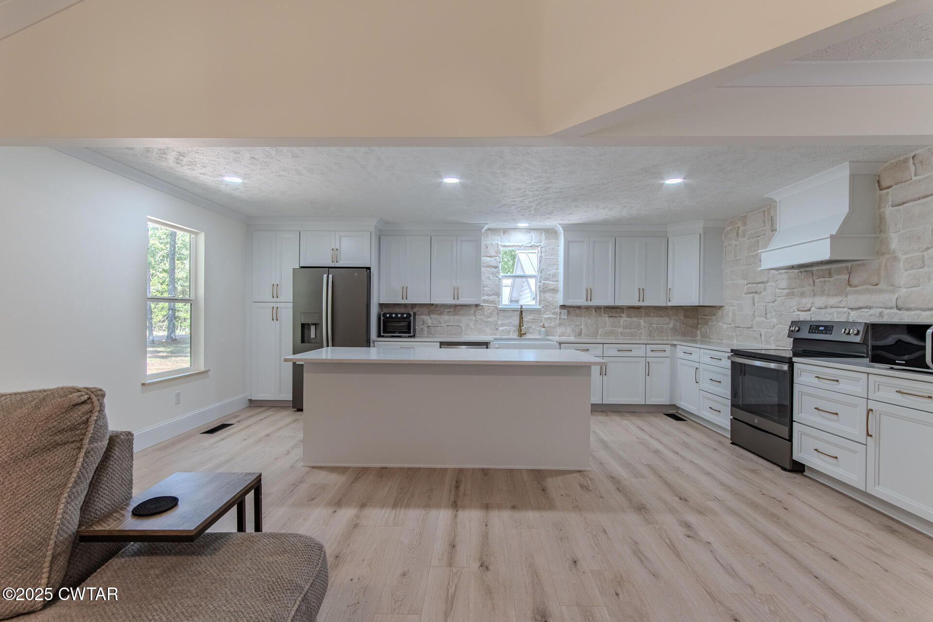 1000 Verles King Road Medon, TN 38356 - Photo 6 of 34 a large kitchen with kitchen island a white counter space a sink a stove and a window