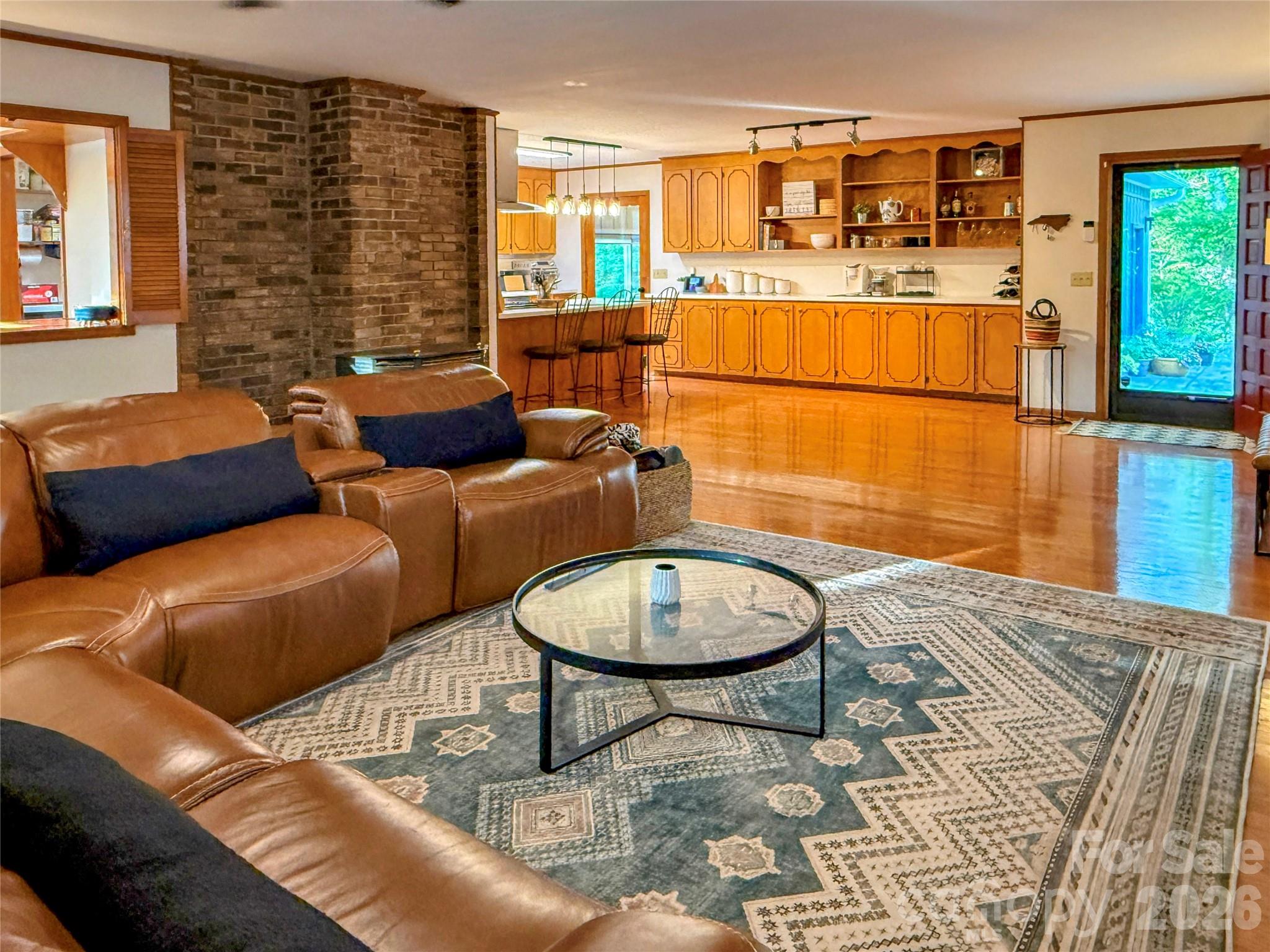 550 South River Road Tryon, NC 28782 - Photo 14 of 47 a living room with furniture a rug and white walls