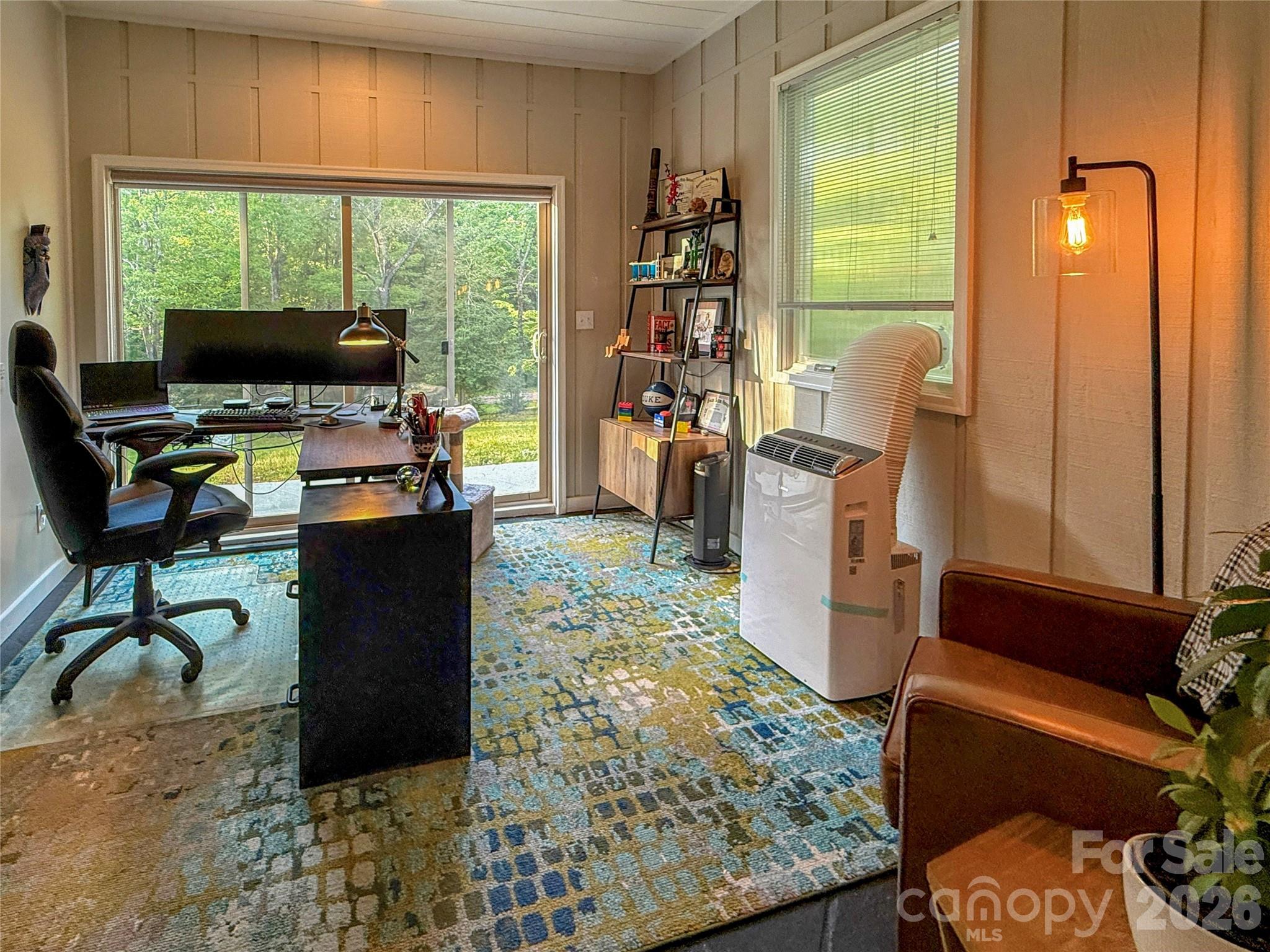550 South River Road Tryon, NC 28782 - Photo 35 of 47 a living room with furniture a flat screen tv and a floor to ceiling window