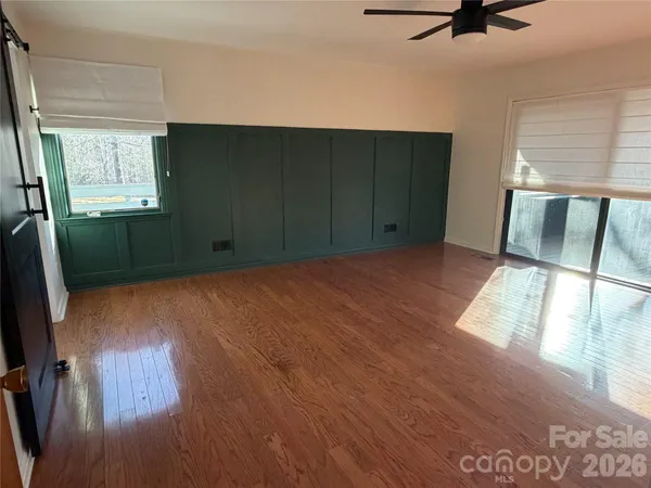 a living room with furniture a rug and white walls
