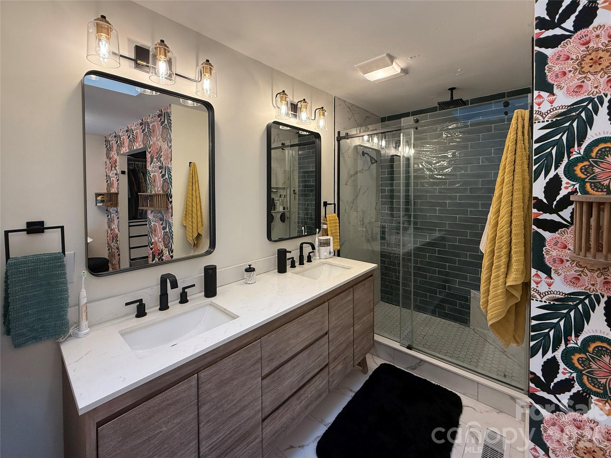 550 South River Road Tryon, NC 28782 - Photo 10 of 47 a bathroom with a sink mirror and shower