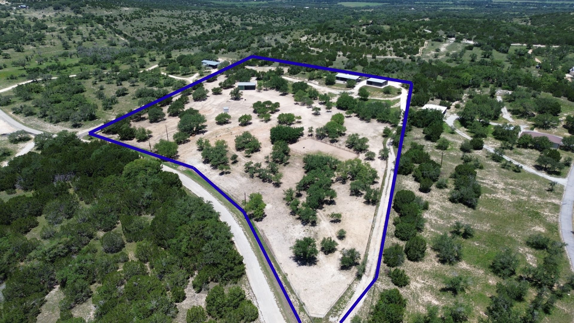 496 Middleton Road Spicewood, TX 78669 - Photo 3 of 40 A sweeping aerial view reveals a vast, tree-dotted lot, ready for your vision to unfold.