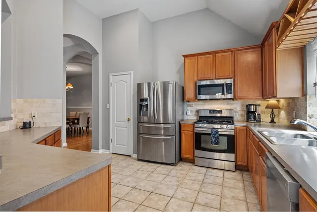 a kitchen with a sink a stove and refrigerator