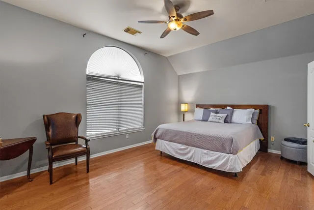 a bedroom with a bed chair and window