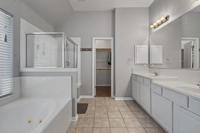 a bathroom with a tub sink and a mirror