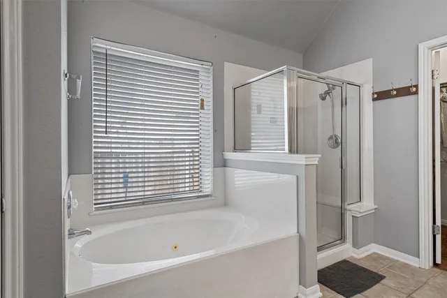 a bathroom with a bathtub and a shower