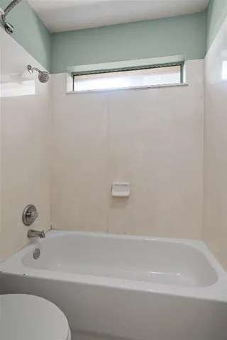 a bathroom with a shower and a bath tub