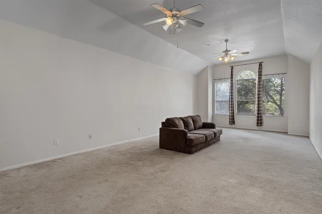 a living room with furniture and chandelier fan