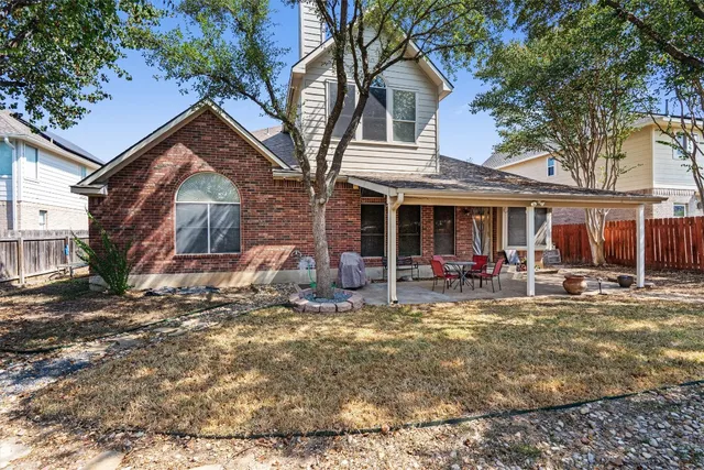 a view of a house with backyard porch and sitting area