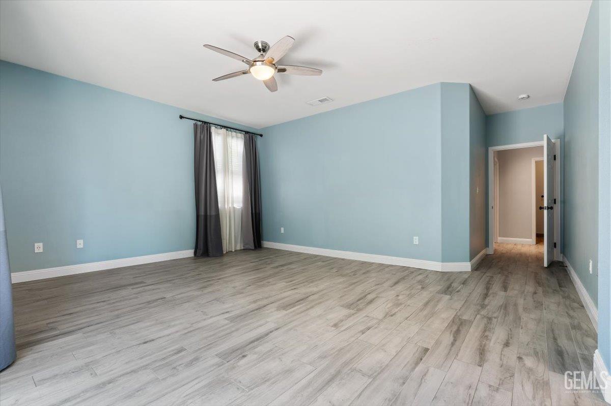 Undisclosed Address Bakersfield, CA 93312 - Photo 12 of 45 wooden floor in an empty room with a window