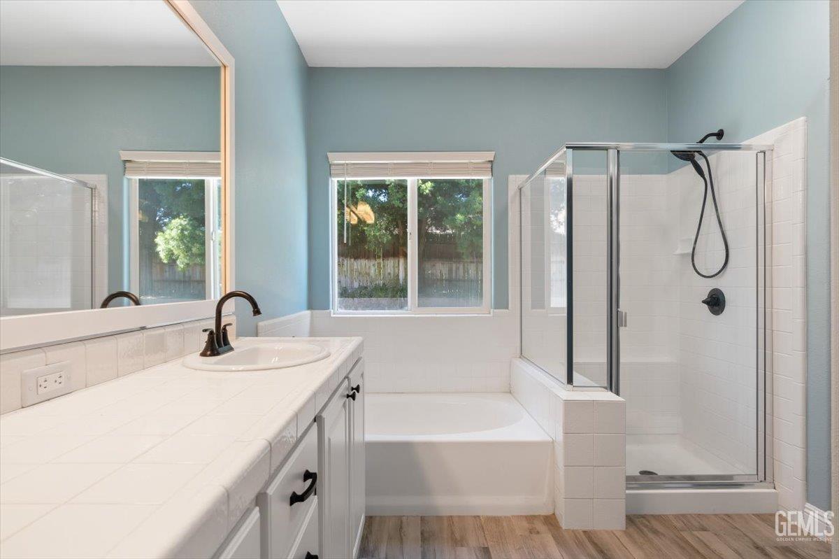 Undisclosed Address Bakersfield, CA 93312 - Photo 16 of 45 a bathroom with a tub sink and mirror