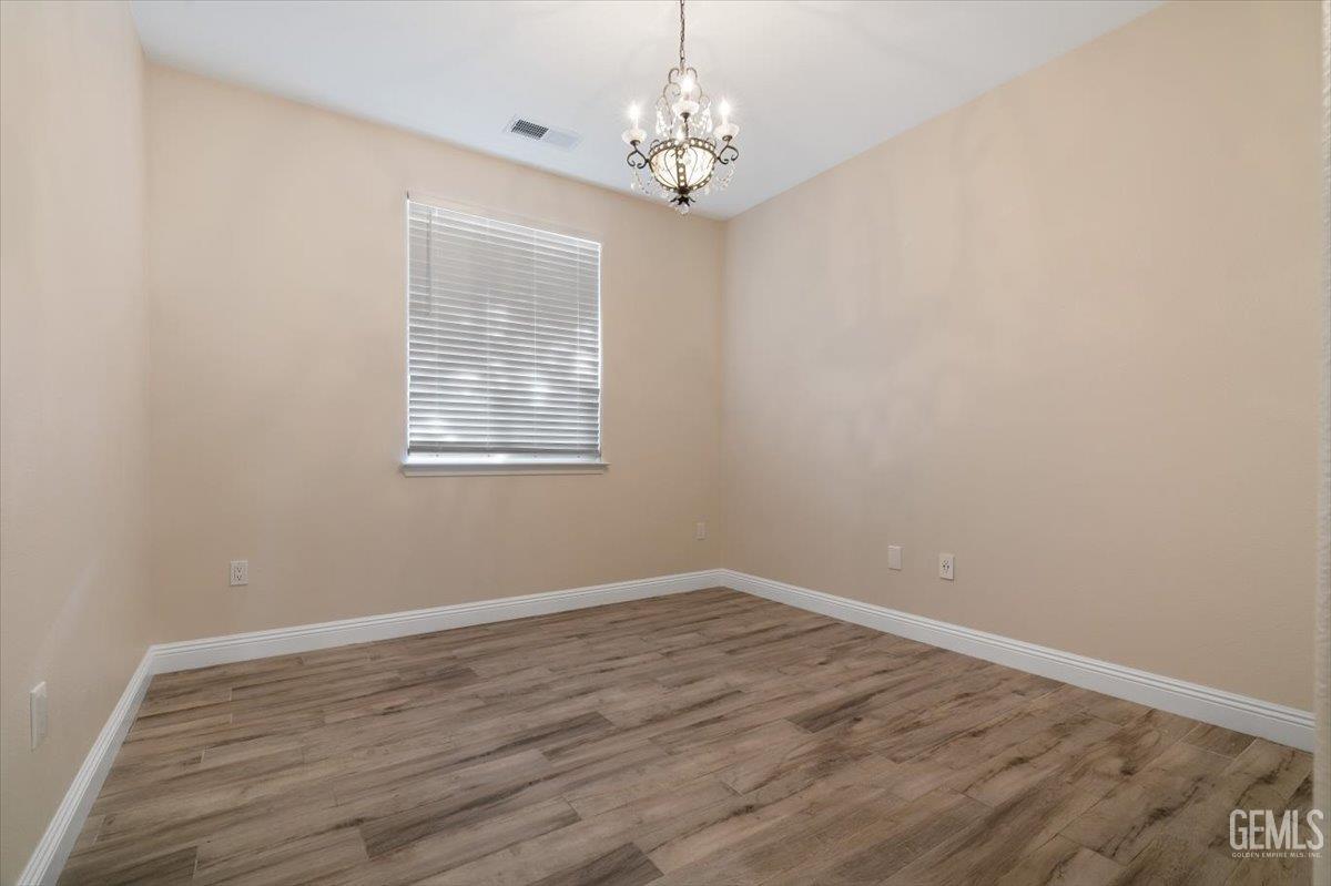 Undisclosed Address Bakersfield, CA 93312 - Photo 20 of 45 a view of a big room with wooden floor and windows