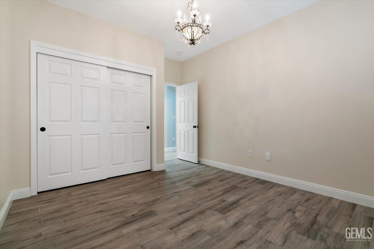 Undisclosed Address Bakersfield, CA 93312 - Photo 21 of 45 wooden floor in an empty room with a window