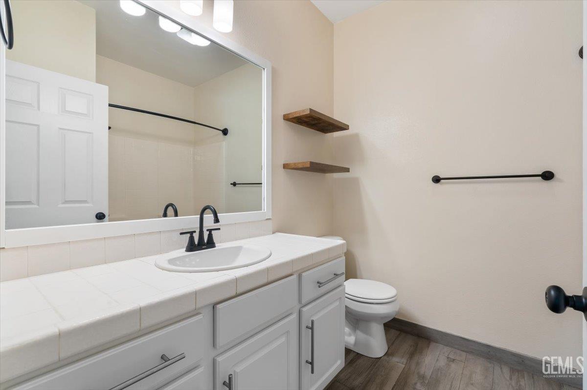 Undisclosed Address Bakersfield, CA 93312 - Photo 22 of 45 a bathroom with a sink a toilet and shower