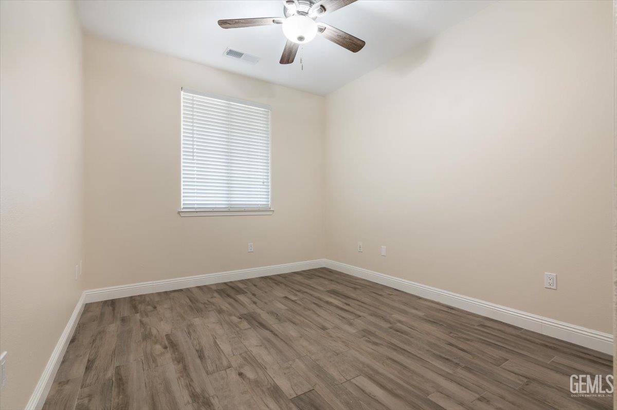 Undisclosed Address Bakersfield, CA 93312 - Photo 24 of 45 wooden floor in an empty room with a window