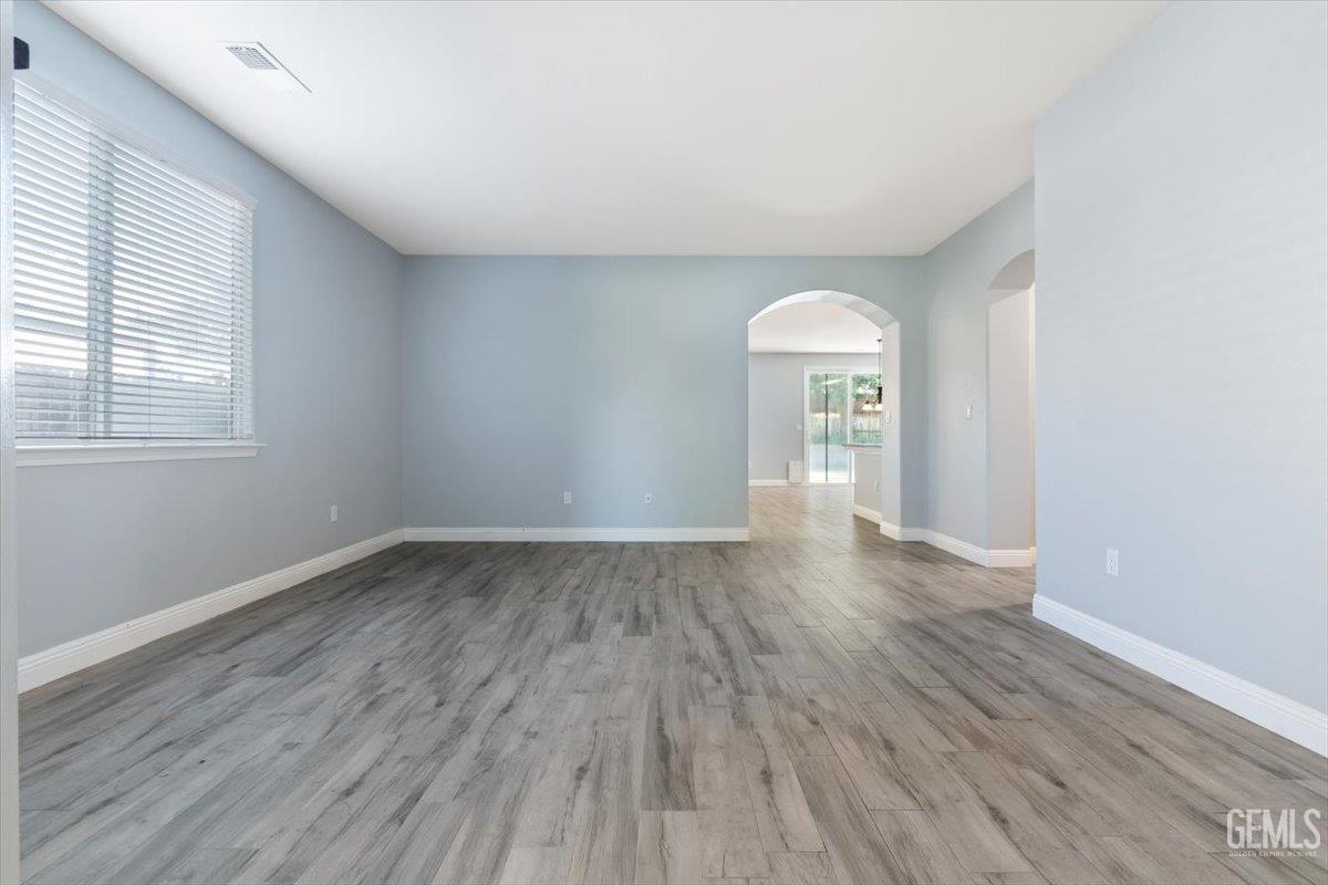 Undisclosed Address Bakersfield, CA 93312 - Photo 28 of 45 an empty room with wooden floor and windows