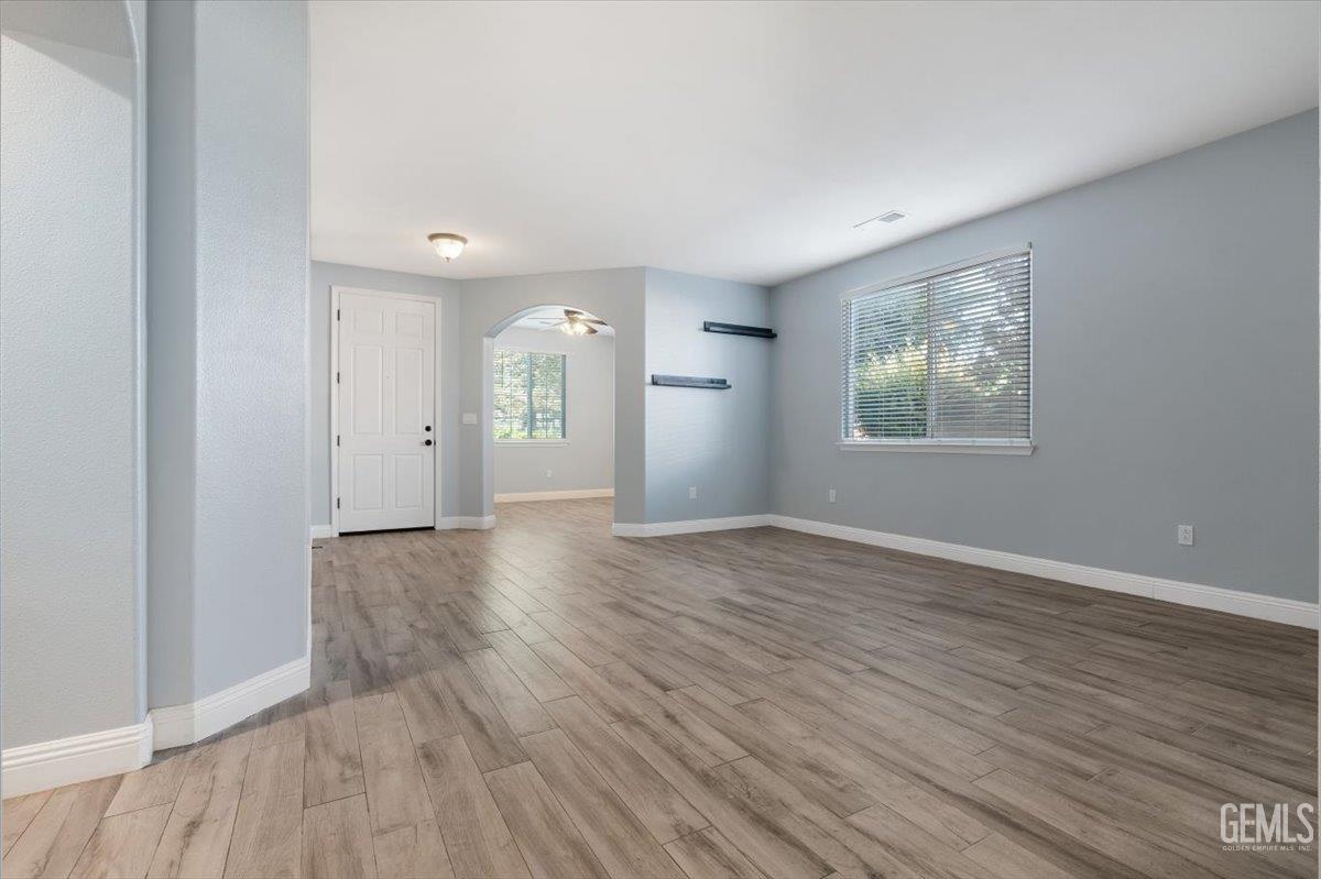 Undisclosed Address Bakersfield, CA 93312 - Photo 29 of 45 an empty room with wooden floor and windows